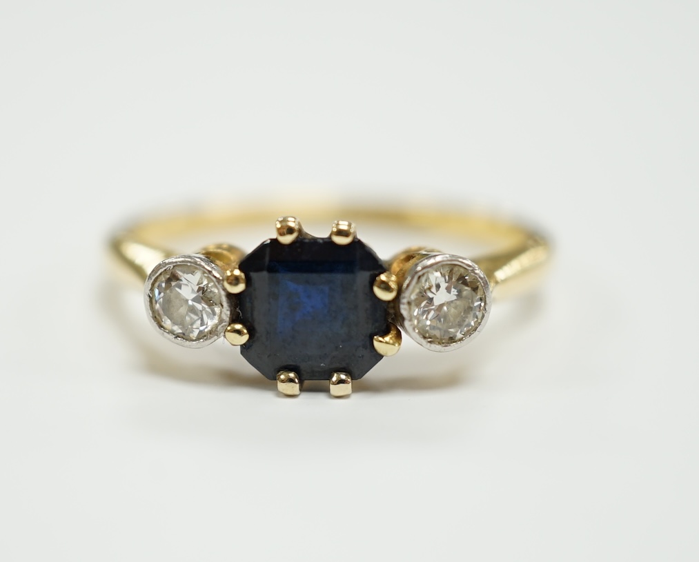 An 18ct and plat, single stone sapphire and two stone diamond set ring, size O/P, gross weight 3.1 grams.